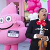 Cristina Lopez of The Mariachi Nuestras Raices performs next to Pinkbox mascot Pinky during a Pinkbox Doughnuts ribbon-cutting event Thursday, March 9, 2023.