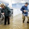 Pamela and Patrick Cerruti empty coins from Pajaro Coin Laundry as floodwaters surround machines in the community of Pajaro in Monterey County, Calif., Tuesday, March 14, 2023. "We lost it all. That's half a million dollars of equipment," said Pamela who added that they plan to rebuild. 


