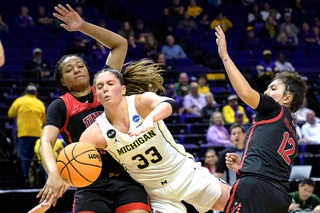 Michigan forward Emily Kiser (33) is fouled by UNLV forward Alyssa Brown (44) in the second half of a first-round college basketball game in the women's NCAA Tournament in Baton Rouge, La., Friday, March 17, 2023,
