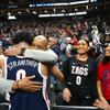 Gonzaga Bulldogs guard Julian Strawther (0) hugs his father Lee as his sisters Paris, center, and Paige look on after Gonzagas 79-76 victory over UCLA in a Sweet Sixteen NCAA Tournament basketball game at T-Mobile Arena Thursday, March 23, 2023.