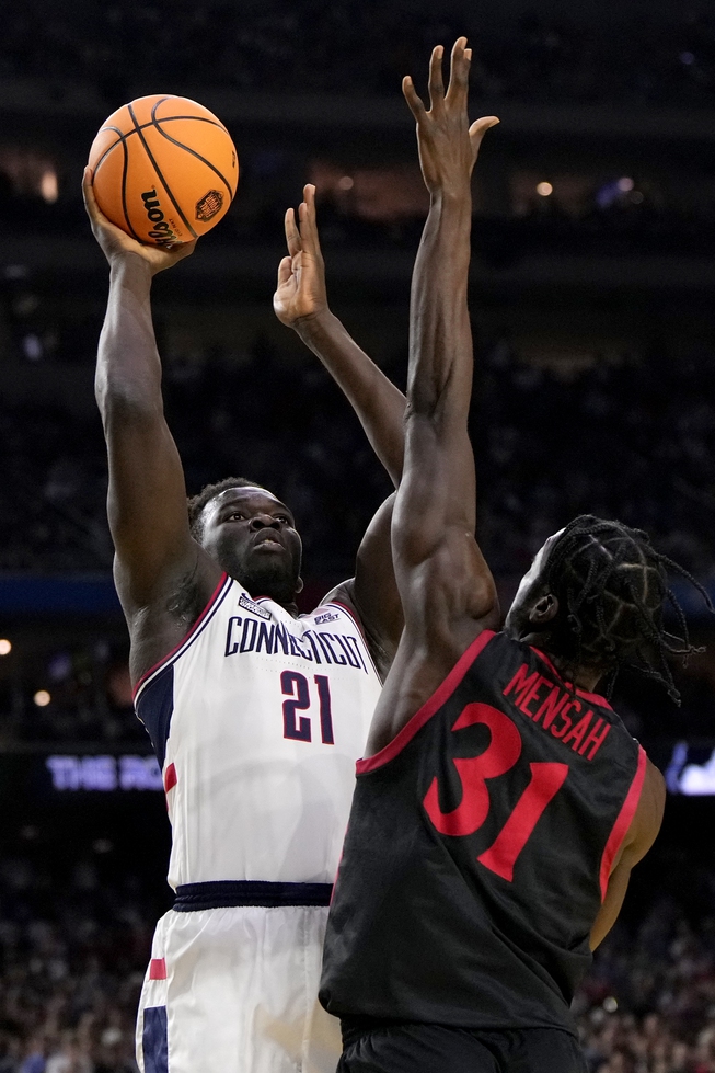Connecticut forward Adama Sanogo (21) shoots over San Diego State forward Nathan Mensah (31) during the first half of the men's national championship college basketball game in the NCAA Tournament on Monday, April 3, 2023, in Houston. 


