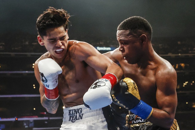 Ryan Garcia, left, and Javier Fortuna exchange punches during a lightweight boxing match Saturday, July 16, 2022, in Los Angeles.
