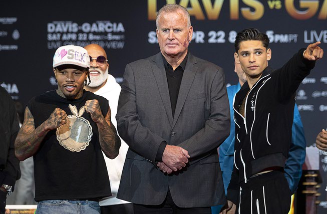Undefeated lightweight boxer Gervonta Davis, left, and undefeated super lightweight boxer Ryan Garcia pose during a news conference at the MGM Grand hotel-casino Thursday, April 20, 2023, in Las Vegas. Boxing promoter Tom Brown, center, separates the fighters.The boxers are scheduled to fight in a 136-pound catchweight bout at T-Mobile Arena in Las Vegas on Saturday, April 22, 2023.