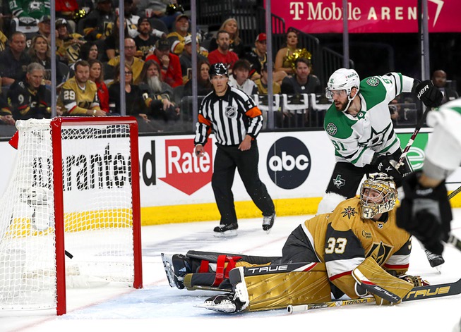 Dallas Stars center Tyler Seguin (91) watches as a puck shot by left wing Jason Robertson gets past Vegas Golden Knights goaltender Adin Hill (33) during the second period of Game 2 of an NHL hockey Stanley Cup Western Conference Final at T-Mobile Arena Sunday, May 21, 2023, in Las Vegas.