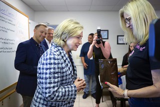 Former Secretary of State and former first lady Hillary Clinton looks at an overdose rescue kit held by volunteer Kriss Wright during a tour and news conference at the Foundation for Recovery in Las Vegas Wednesday, May 24, 2023. A tour and news conference by Clinton at the Foundation for Recovery office were part of the efforts by the Clinton Global Initiative to prevent overdose deaths.