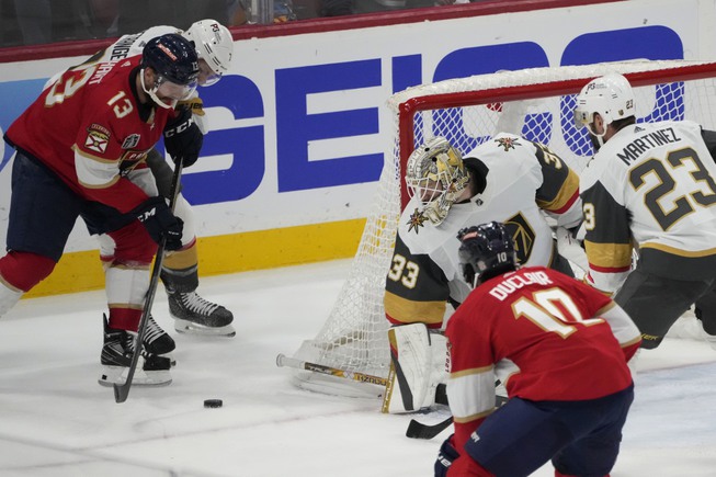 Vegas Golden Knights goaltender Adin Hill (33) defends the net from a shot from Florida Panthers center Sam Reinhart (13) during the third period of Game 3 of the Stanley Cup Finals, Thursday, June 8, 2023, in Sunrise, Fla. 


