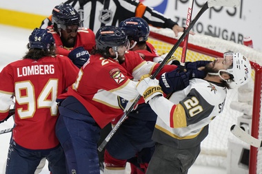 Florida Panthers defenseman Josh Mahura (28) and Vegas Golden Knights center Chandler Stephenson (20) fight during the third period in Game 4 of the NHL hockey Stanley Cup Finals, Saturday, June 10, 2023, in Sunrise, Fla.