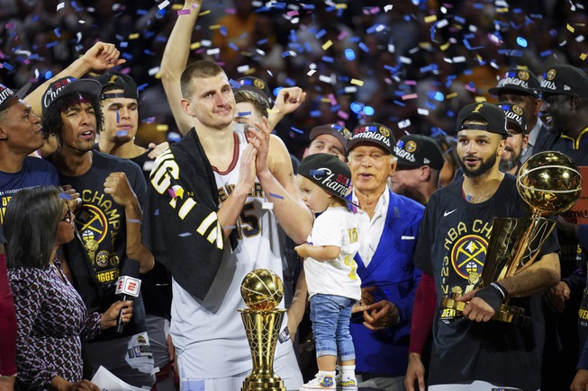 Denver Nuggets center Nikola Jokic, center left, celebrates with teammates after the team won the NBA Championship with a victory over the Miami Heat in Game 5 of the NBA Finals, Monday, June 12, 2023, in Denver. 


