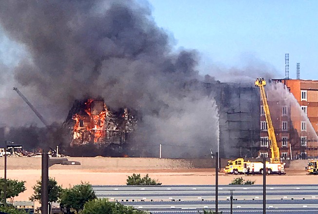 A fire burns at a multi-story building under construction near the I-215 Beltway and Durango Drive Tuesday, June 20, 2023.
