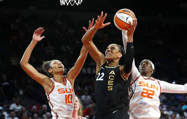 Las Vegas Aces forward A'ja Wilson (22) goes up for a shot between Connecticut Sun forwards Olivia Nelson-Ododa (10) and Liz Dixon (22) during the second half of a WNBA basketball game at Michelob Ultra Arena in Mandalay Bay Saturday, July 1, 2023.