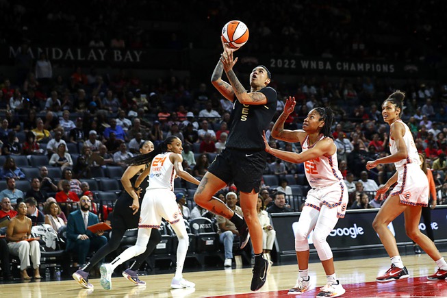 Las Vegas Aces guard Kierstan Bell (1) drives to the basket ahead of Connecticut Sun guard Tyasha Harris (52) during the second half of a WNBA basketball game at Michelob Ultra Arena in Mandalay Bay Saturday, July 1, 2023.