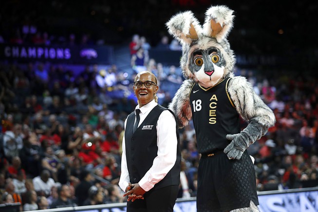 Buckets, the Las Vegas Aces mascot, performs behind Cynthia Lee during a break in a WNBA basketball game between the Las Vegas Aces and the Connecticut Sun at Michelob Ultra Arena in Mandalay Bay Saturday, July 1, 2023.