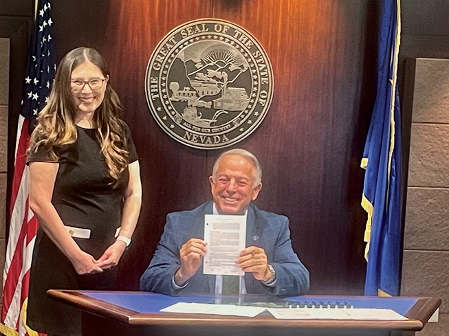 Clark County Family Court Judge Sunny Bailey, left, and Gov. Joe Lombardo mark the ceremonial signing of Senate Bill 411, which establishes a statewide diversionary court program for at-risk adolescent youths with autism. Bailey in 2018 spearheaded the successful Detention Alternative for Autistic Youth Court in Clark County, which will serve as a model for the statewide program.