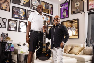 Basketball Hall of Fame inductee Spencer Haywood, left, and Film and music producer Vassal Benford pose for a photo with one of B.B. King's guitars during an interview Friday, July 28, 2023.