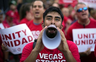 Members of the Culinary Workers Union rally along the Las Vegas Strip, Thursday, Aug. 10, 2023, in Las Vegas. The union rallied to support servers, dishwashers, cooks and bartenders who work at T-Mobile Arena and have been locked in contract negotiations for nearly a year with their employer, Levy Premium Food Service.