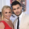 Britney Spears and Sam Asghari appear at the Los Angeles premiere of "Once Upon a Time in Hollywood" on July 22, 2019. Spears has reached a divorce settlement with her soon-to-be-ex-husband Asghari.