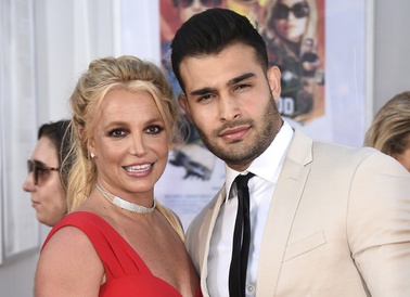Britney Spears and Sam Asghari appear at the Los Angeles premiere of "Once Upon a Time in Hollywood" on July 22, 2019. Spears has reached a divorce settlement with her soon-to-be-ex-husband Asghari.