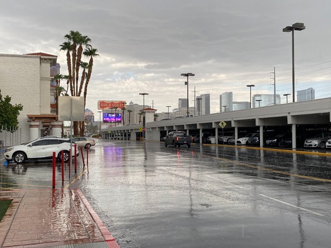 The sign for Gold Coast can be seen as rain pours down in the area near the Las Vegas Strip on Friday, Aug. 18, 2023. Historic flooding was predicted by the National Weather Service for the weekend.