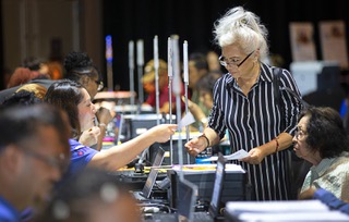 Sandra Alvarado, standing, helps her mother Flora sign up for utility assistance during a Project Reach Senior Expo at Sams Town Thursday, Aug. 24, 2023. The expos, a partnership of United Way of Southern Nevada and the NV Energy Foundation, provide assistance with utilities for low-income people age 62 or older.