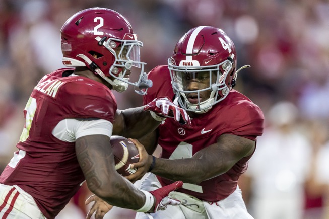 Alabama quarterback Jalen Milroe (4) hands off the ball to Alabama running back Jase McClellan (2) during the first half an NCAA college football game against Middle Tennessee, Saturday, Sept. 2, 2023, in Tuscaloosa, Ala.