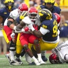 UNLV running back Jai'Den Thomas (22) is stopped by Michigan defensive lineman Cam Goode (99) in the second half of an NCAA college football game in Ann Arbor, Mich., Saturday, Sept. 9, 2023.