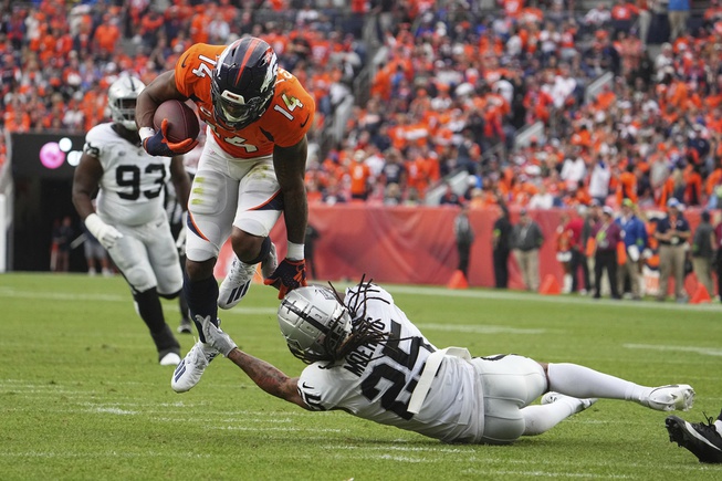 Denver Broncos wide receiver Courtland Sutton (14) catches the ball against the Las Vegas Raiders of an NFL football game Sunday August 10, 2023, in Denver. 