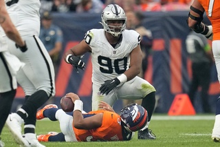 Denver Broncos quarterback Russell Wilson is sacked by Las Vegas Raiders defensive tackle Jerry Tillery (90) during the second half of an NFL football game, Sunday, Sept. 10, 2023, in Denver. 