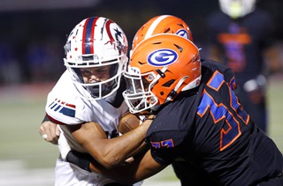 Liberty wide receiver Brody Armani (6) is tackled by Bishop Gorman defensemen Charles Correa (10) and Hayden Stepp (32)during the first half of a high school football game at Fertitta Field Thursday, Sept. 14, 2023.