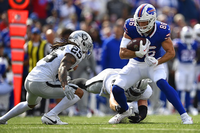 Las Vegas Raiders' Tre'von Moehrig (25) tackles Buffalo Bills' Dalton Kincaid (86) during the second half of an NFL football game, Sunday, Sept. 17, 2023, in Orchard Park, N.Y. (AP Photo/Adrian Kraus)