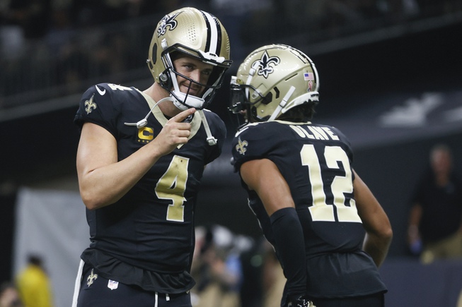 New Orleans Saints quarterback Derek Carr (4) celebrates the team's touchdown with wide receiver Chris Olave (12) in the second half of an NFL football game against the Tennessee Titans in New Orleans, Sunday, Sept. 10, 2023. 


