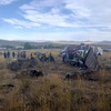 In this photo provided by the Truckee, Calif., Meadows Fire and Rescue Department, members of the Truckee Meadows Fire and Rescue Department and other officials look over aircraft wreckage, Sunday, Sept. 17, 2023, in Reno, Nev., after two California pilots were killed when their planes collided in mid-air while preparing to land after completing a race at the National Championship Air Races north of Reno.