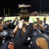 Chaparral players celebrate with the Cleat Trophy after defeating Eldorado in a high school football game at Chaparral High School Friday, Sept. 22, 2023. The trophy, awarded to the winner of the annual rivalry game, is a bronzed cleat from NFL Hall of Famer Merlin Olsen. Chaparral defeated Eldorado 32-18.