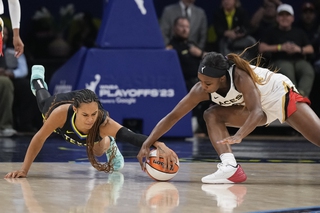Dallas Wings forward Satou Sabally, left, and Las Vegas Aces guard Jackie Young scramble for the ball during the first half of Game 3 of a WNBA playoffs semifinal Friday, Sept. 29, 2023, in Arlington, Texas. 



