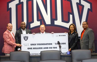 Las Vegas Raiders owner Mark Davis, center, poses with an oversized check during a news conference at the Fertitta Football Complex at UNLV Tuesday, Oct. 3, 2023. With Davis from left: UNLV head coach BarryOdom, UNLV athletic director Erick Harper, Raiders president Sandra Douglass Morgan, and UNLV president Keith Whitfield. The Raiders announced Monday that the organization plans to donate $1 million to the UNLV football program.