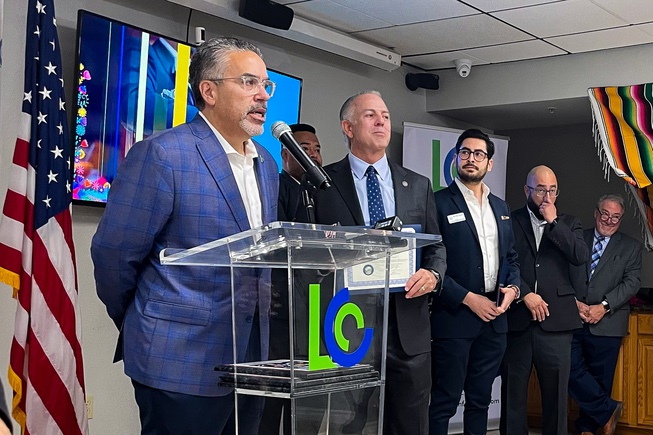  Latin Chamber of Commerce President Peter Guzman, left, and Nevada Gov. Joe Lombardo, second to the left, take turns speaking at an event hosted by the chamber on Oct. 5, 2023.