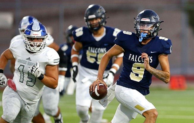 Foothill quarterback Mason Dew (9) keeps the ball as Green Valley defensive tackle Shawn Mckeon (15) pursues during the first half of a high school football game at Foothill High School in Henderson Friday, Oct. 6, 2023.