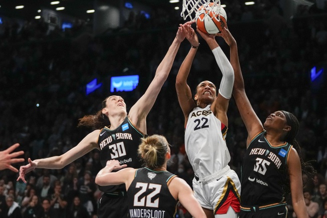 New York Liberty's Jonquel Jones (35), Courtney Vandersloot (22) and Breanna Stewart (30) defend a shot by Las Vegas Aces' A'ja Wilson (22) during the second half in Game 4 of the WNBA Finals on Wednesday, Oct. 18, 2023, in New York. The Aces won 70-69. 


