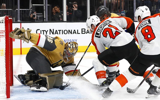 Vegas Golden Knights goaltender Logan Thompson (36) stops a shot by Philadelphia Flyers center Scott Laughton (21) during the second period of an NHL hockey game at T-Mobile Arena Tuesday, Oct. 24, 2023.
