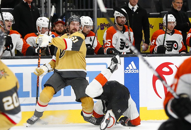 Philadelphia Flyers left wing Noah Cates (27) fall by Vegas Golden Knights right wing Mark Stone (61) during the third period of an NHL hockey game at T-Mobile Arena Tuesday, Oct. 24, 2023.