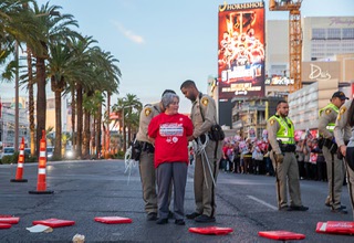 A member of the Culinary Workers Union, Local 226, is arrested as union membership and leaders block traffic on the Las Vegas Strip during a civil disobedience protest Wednesday, Oct. 25, 2023. The union is currently in contract negotiations with the casinos.