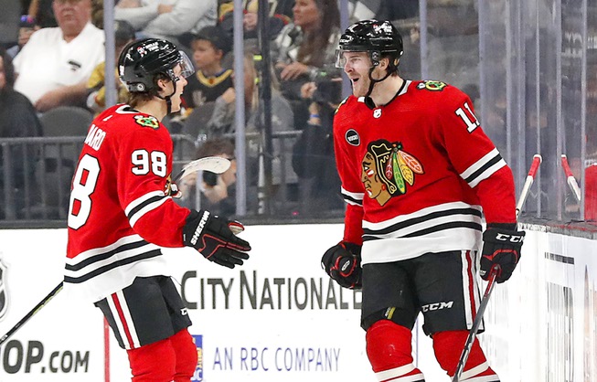Chicago Blackhawks center Connor Bedard (98) celebrates with Chicago Blackhawks right wing Taylor Raddysh (11) after Raddysh scored against the Vegas Golden Knights during the third period of an NHL hockey game at T-Mobile Arena Friday, Oct. 27, 2023.