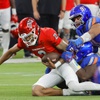 UNLV quarterback Doug Brumfield (2) is sacked by Boise State nose tackle Herbert Gums (98) and defensive end Ahmed Hassanein (91) during the second half of the Mountain West championship football game at Allegiant Stadium Saturday, Dec. 2, 2023.