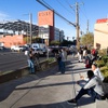 UNLV students wait along Maryland Parkway after being evacuated due to a fatal shooting after a fatal shooting on the UNLV campus Wednesday, Dec. 6, 2023.