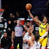 Indiana Pacers guard Tyrese Haliburton (0) shoots over Milwaukee Bucks center Brook Lopez (11) during the first half of an NBA In-Season Tournament semifinal game at T-Mobile Arena Thursday, Dec. 7, 2023, in Las Vegas. The Pacers defeated the Bucks 128-119.