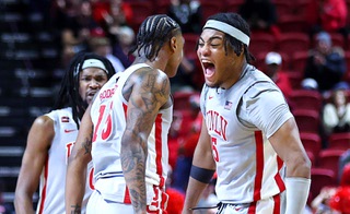 UNLV Rebels guard Luis Rodriguez (15) and forward Rob Whaley Jr. (5) celebrate after Rodriguez scored a basket and drew a foul during the second half of an NCAA basketball game against the Hofstra Pride at the Thomas & Mack Center Thursday, Dec. 21, 2023.