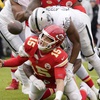 Kansas City Chiefs quarterback Patrick Mahomes (15) fumbles as he is hit by Las Vegas Raiders defensive end Malcolm Koonce (51) during the first half of an NFL football game Monday, Dec. 25, 2023, in Kansas City, Mo.