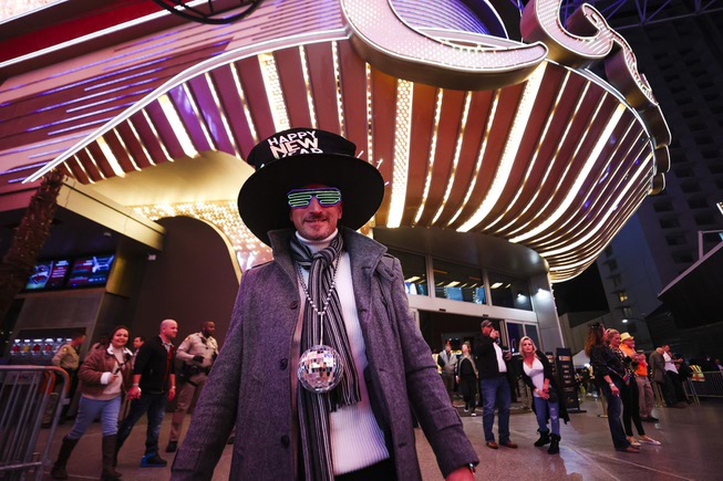Mike Waller of Los Angeles poses for a photo at the Fremont Street Experience in Downtown Las Vegas on New Years Eve Sunday, Dec. 31, 2023.