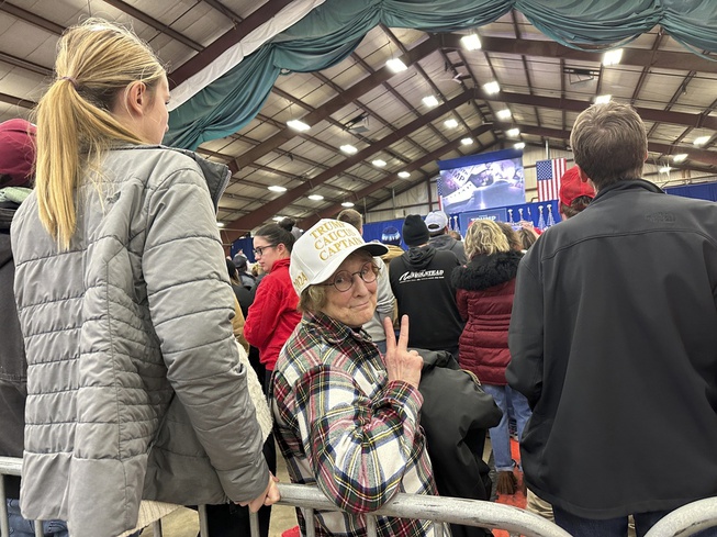 Jackie Garlock, of Clear Lake, Iowa, wears a white hat indicating her status as one of Donald Trump's "caucus captains" while attending his rally in Mason City, Iowa, on Friday, Jan. 5, 2024. She says she's not particularly good at political organizing but has confidence Trump will win the Republican caucuses on Jan. 15.