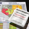 A radon test kit is shown on a map of Clark County showing radon potential by zip code at the Local Realty office Thursday, Jan. 11, 2024. The red color indicates a high potential for radon exposure.