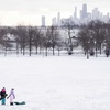 Friends Parker Melowsky, left, 7, and Quinlynn, 6, walk up Cricket Hill, which overlooks the Chicago skyline, in the Uptown neighborhood after a major snowstorm hit the Chicago area, Saturday, Jan. 13, 2024.